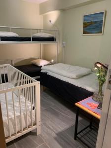 a bedroom with two bunk beds and a crib at Svea Hostel in Stockholm