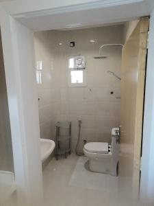 a white bathroom with a toilet and a sink at شقة 3 احد رفيدة حي الخليج in Ahad Rafidah +6 photos