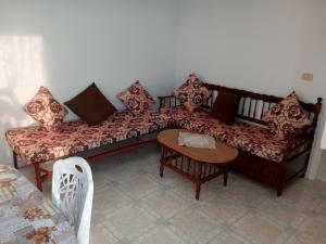 a living room with a couch and a table at Studio AMINE in Mahdia