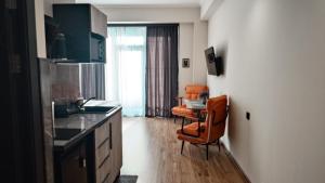 a kitchen with an orange chair and a sink at ALVINA Complex Tsaghkadzor in Tsaghkadzor