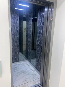 a shower in a bathroom with a mirror at Herăstrău WIN Résidence No 4 in Bucharest +26 photos