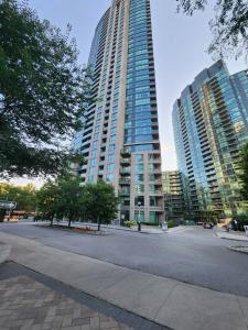 a large tall building with a street in front of it at Downtown Toronto Cozy Suite in Toronto