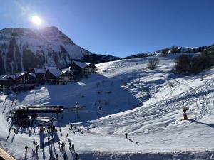 a group of people skiing down a snow covered mountain at Appartement Lunik Orion, 6 personnes, vue piste, Le Corbier, Les Sybelles in Villarembert +2 photos
