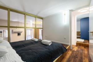 a bedroom with a large bed with two pillows on it at Csarnok Apartment in Budapest