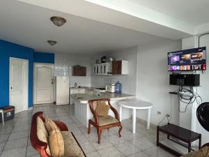 a kitchen with a couch and a table in a room at Casa blanca Atacames in Atacames