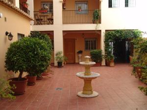 a courtyard with a fountain in front of a building at Carabeo 2000 Nerja in Nerja