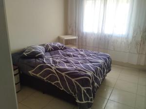 a bedroom with a bed and a window with curtains at CASA COM 3 QUARTOS, SENDO 1 QUARTO Suite in Pinhal +11 photos