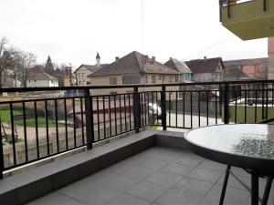 a balcony with a table and a fence at Perfect Stay in Sibiu
