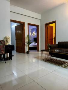 a living room with a couch and a piano at Luxurious 2 Bed Apartment in Islamabad