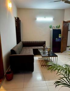 a living room with a couch and a table at Luxurious 2 Bed Apartment in Islamabad