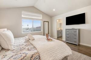 a bedroom with a large bed and a flat screen tv at Game Night Meets Wine Country Elegance in Santa Rosa