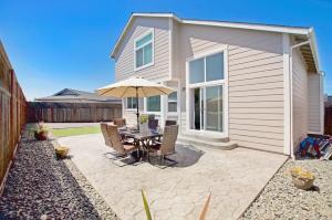 a patio with a table and an umbrella at Game Night Meets Wine Country Elegance in Santa Rosa
