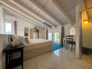 a bedroom with a large bed and a table at Tenuta Feraxi - Private Paradise in San Priamo