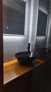 a bathroom with a black sink and a mirror at Châtel - Les Perthuis in Châtel +18 photos