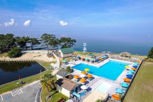 an aerial view of a resort swimming pool with umbrellas at 5517 - Harbour Haven in Kill Devil Hills