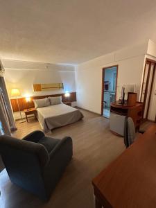a hotel room with a bed and a couch at Flat Ibirapuera V Mariana Borges Lagoa com garagem 512 in Sao Paulo +34 photos