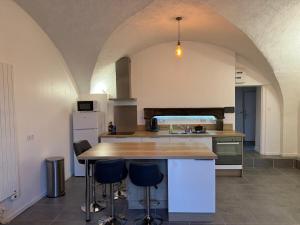 a kitchen with a wooden counter top in a room at Appartement de caractère Val 1 in Beaumont