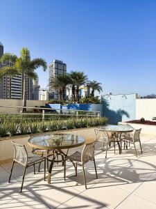 a group of tables and chairs on a patio at #506# Apto de 1 quarto -Lounge 22 in Goiânia