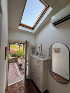 a bathroom with a mirror and a sink at Stylish Stone House for Two in Koločep