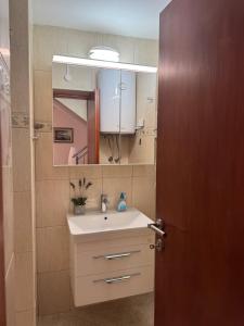 a bathroom with a sink and a mirror at Stylish Stone House for Two in Koločep +21 photos