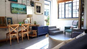 a living room with a desk and chairs and a couch at The Art Room in Somerset West