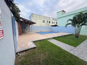 a swimming pool in the yard of a house at Residencial Brasil Coroa - Staybeach in Porto Seguro