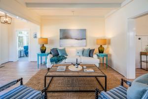 a living room with a couch and two tables at The Sea Captains House by Paradise Retreats in Santa Barbara
