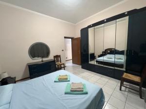 a bedroom with a bed with two towels on it at Apartment in Alexandria! in Alessandria