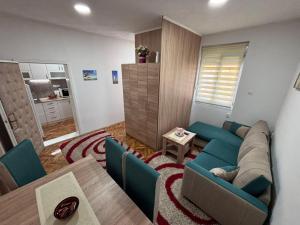 a living room with a couch and a table at Apartman Dunja 2 in Šid