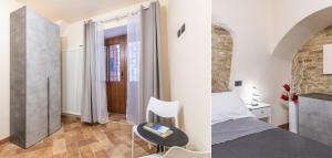 a bedroom with a bed and a room with a table at Locazione Turistica Via Saffi 10 Gubbio in Gubbio