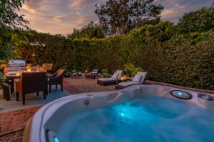 a jacuzzi tub in a yard with a patio at Tropical Retreat by Paradise Retreats in Santa Barbara