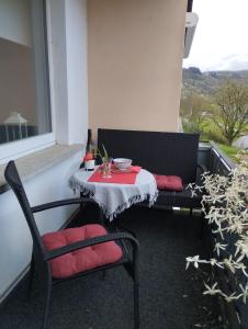 a table and two chairs sitting on a balcony at Ferienwohnung Moselherz in Reil