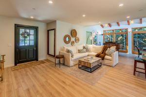 a living room with a couch and a table at Tropical Retreat North by Paradise Retreats in Santa Barbara +21 photos