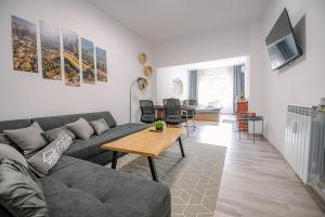 a living room with a couch and a table at Two Luxury Condos by NDK and National Stadium with 2 Free Parking Spots in Sofia