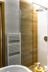 a bathroom with a shower with a toilet and a sink at Pensiunea Poienita Ursului in Fundata
