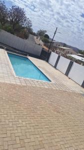 a swimming pool on the side of a house at Serenity in Windhoek