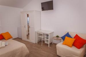 a room with two beds and a table and a desk at Il Nibbio Reale in Albano di Lucania