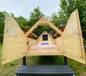 a bed in a tree house in a field at StarsBox la Duchessa in Levice
