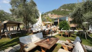 a patio with a table and chairs and tables at Zai Jardin in Fethiye