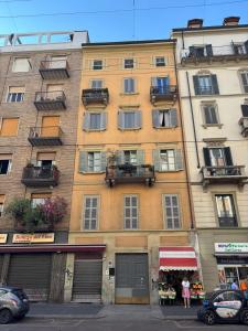 a tall building with windows and balconies on a street at Number one for hospitality Milano Navigli in Milan