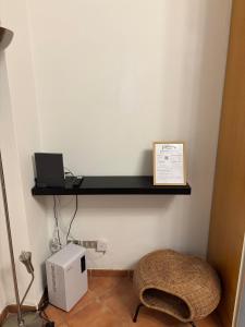 a room with a shelf on the wall with a laptop at Number one for hospitality Milano Navigli in Milan