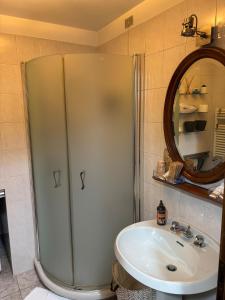 a bathroom with a shower and a sink at Number one for hospitality Milano Navigli in Milan +6 photos