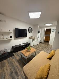 a living room with a flat screen tv on the wall at Villa Massada - déconnexion entre pins & mer in La Seyne-sur-Mer +59 photos