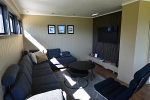 a living room with a couch and a table at Senja Beach Lodge in Senja