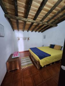 a bedroom with a bed and a wooden ceiling at Campinho Guest house in Campinho +7 photos
