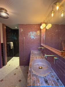 a bathroom with two sinks and a shower at Luxurious vintage loft near city center in Groningen