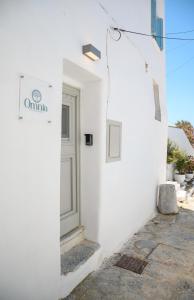 a white building with a sign on the side of it at Omnia Apartments Amorgos Studio in Amorgos