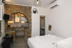 a hotel room with two beds and a sink at Omnia Apartments Amorgos Studio in Amorgos