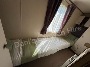 En eller flere senge i et værelse på Sandy Haven