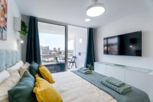 a bedroom with a large bed with a large window at Costa Serena Apartment 420 in Costa de Adeje